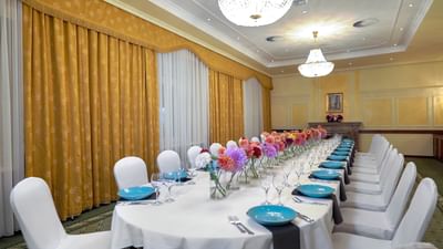 White Chairs and Yellow Curtains at Polonia Palace Hotel Warsaw