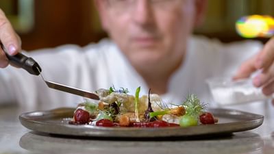 Chef preparing a dish at Polonia Restaurant, Warsaw